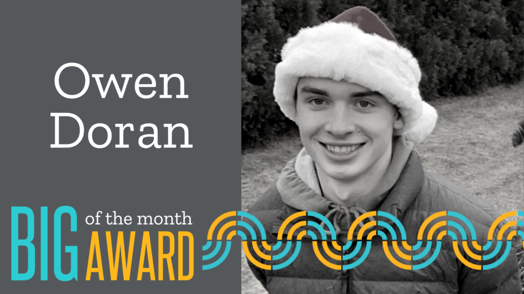Black and white photo of Owen Doran Big of the Month wearing a Santa hat. 